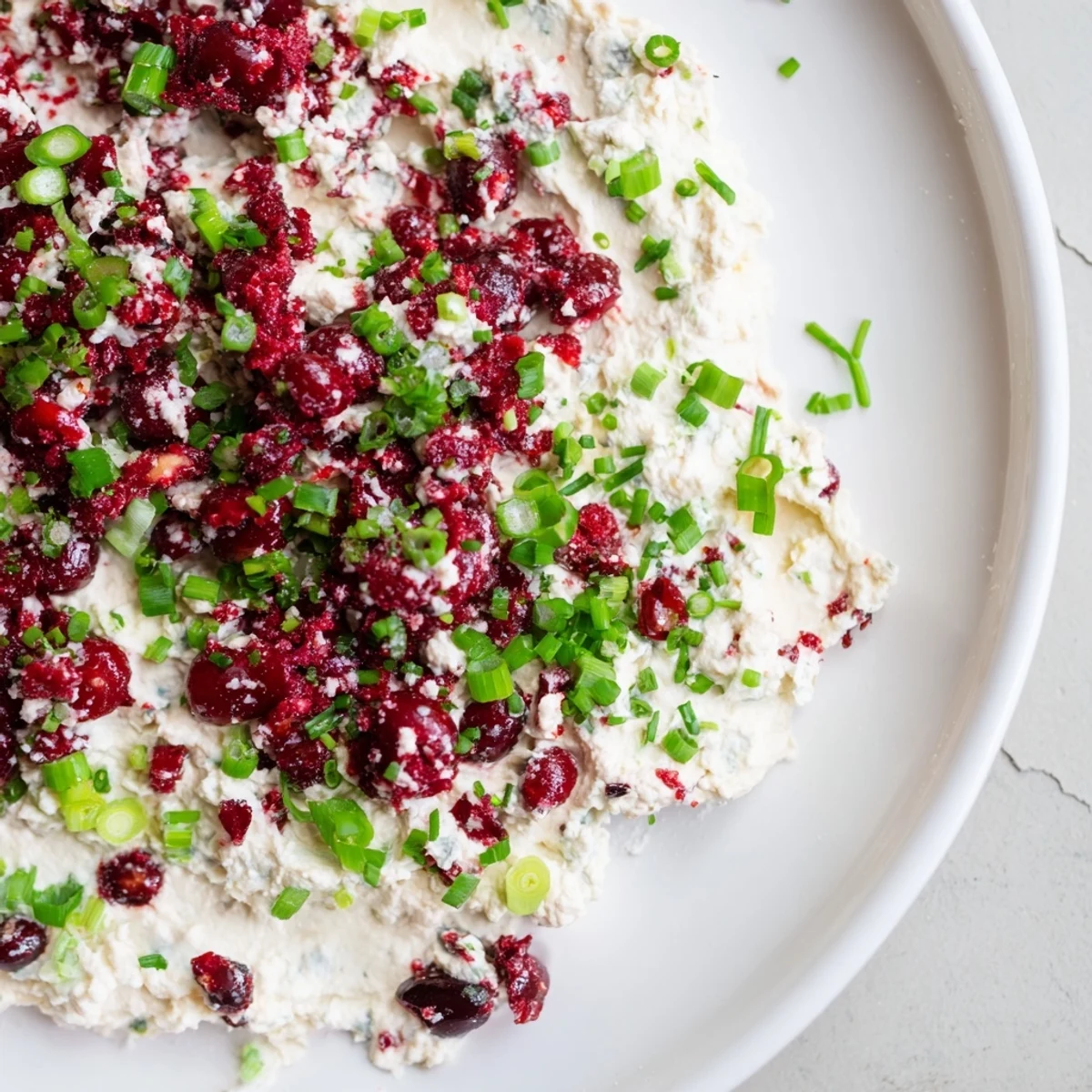 Spicy Ginger Cranberry Jalapeño Dip served with crunchy vegetable sticks for a festive appetizer.  