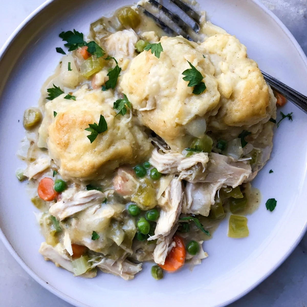 Hearty Chicken and Dumplings Casserole, steaming with tender veggies and savory sauce.  