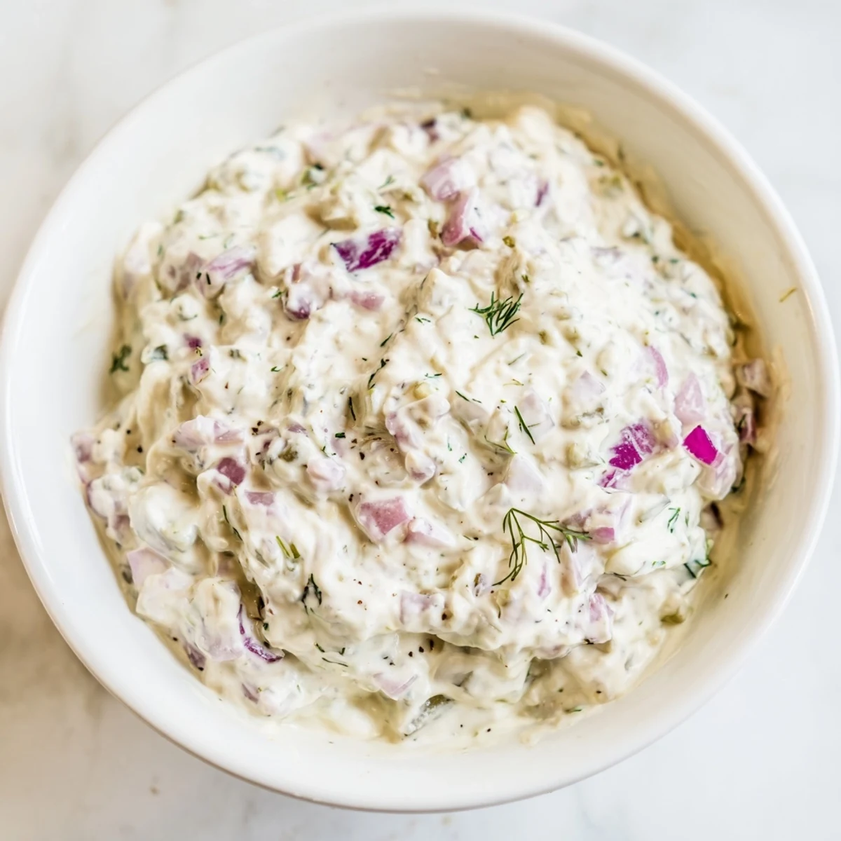 Creamy sweet and sour pickle relish dip with visible relish pieces, perfect for a party appetizer.