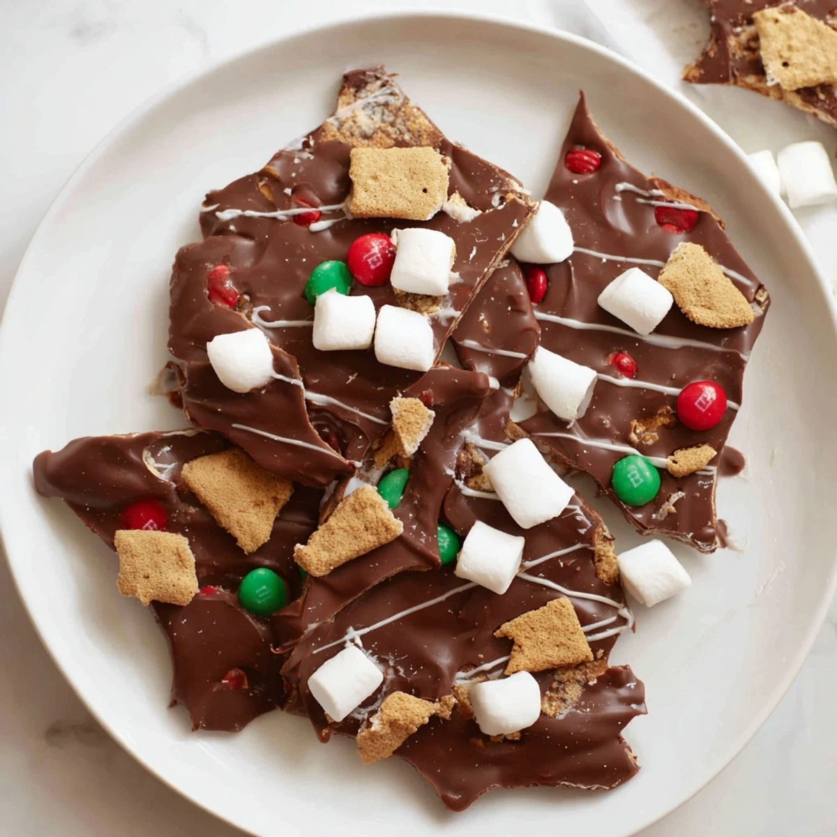 Quick Christmas Smores Bark: Festive chocolate bark with graham crackers, marshmallows and colorful holiday sprinkles.