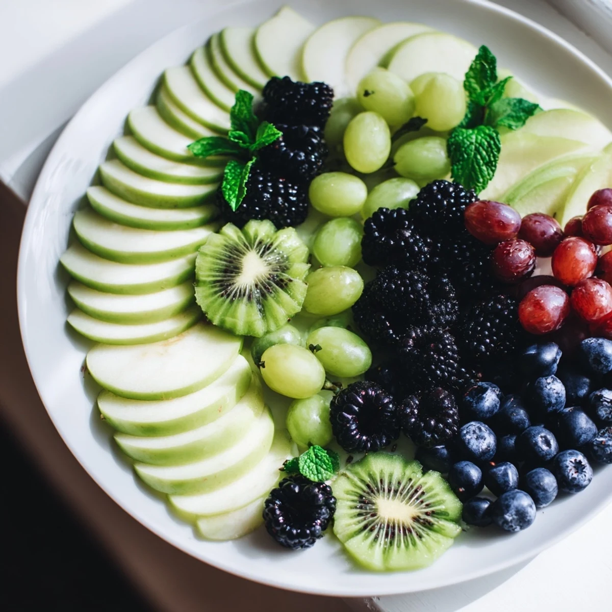 A vividly arranged "Aurora Borealis Sweep" fruit platter—bursts of green and purple fruits shimmer with edible glitter.