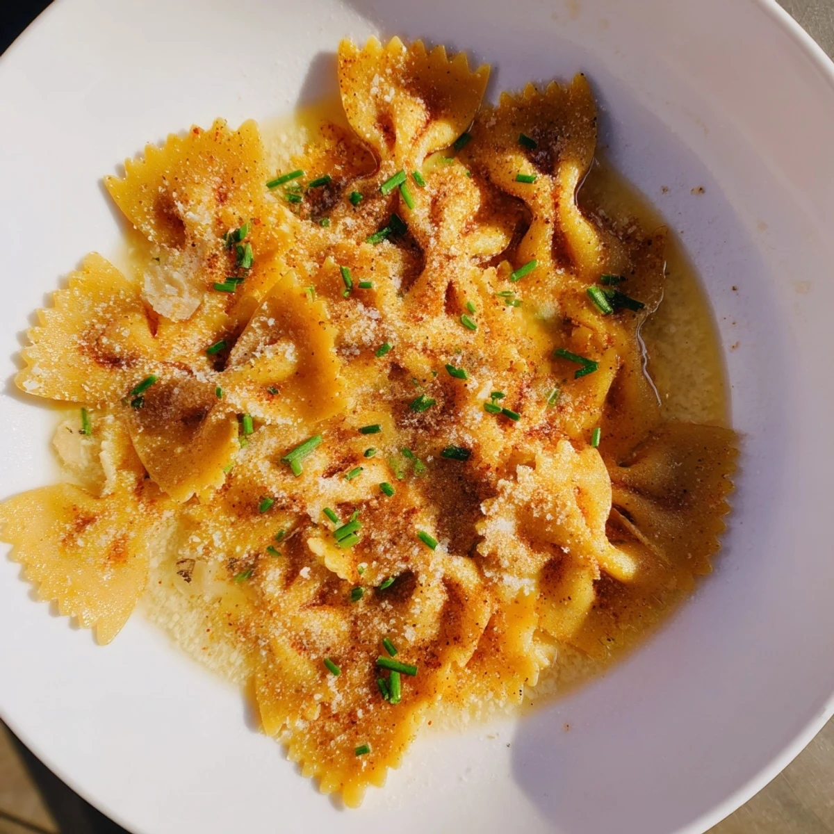 Golden, crispy pasta chip cereal presented in a warm bowl with Parmesan broth, an innovative snack idea.