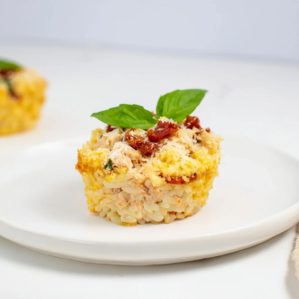 Creamy, golden-topped Marry Me Chicken Sushi Bake Cups, filled with chicken, orzo, and Parmesan.