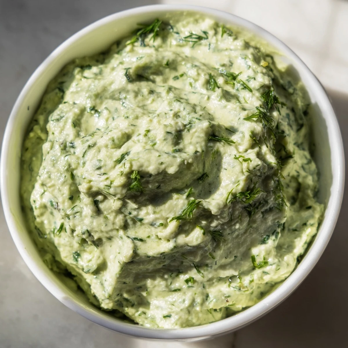 Bright green Green Goddess Dip, creamy and herb-packed, ready to be scooped with crisp, fresh vegetables.