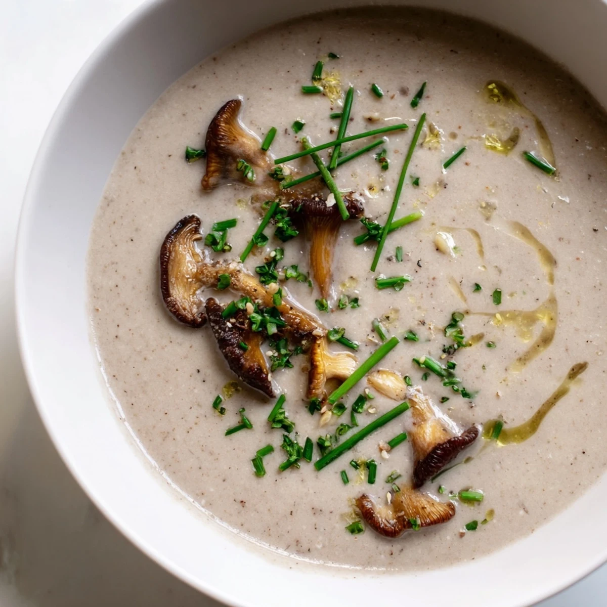 A close-up shot of creamy mushroom bisque, showcasing the perfectly smooth texture and aroma.