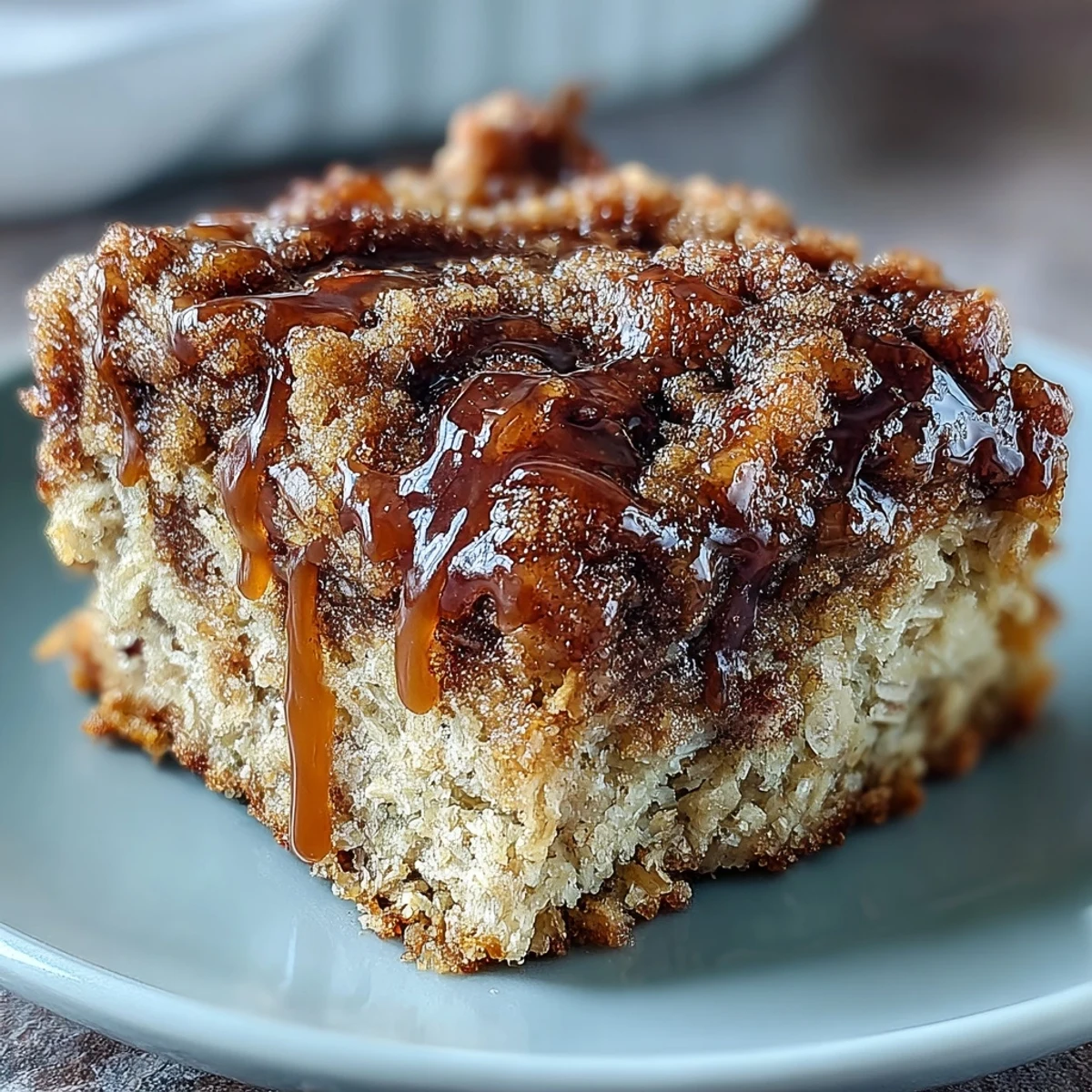 Freshly baked High-Protein Cinnamon Swirl Coffee Cake Oats topped with crumbles and berries in a dish.