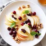 A beautiful Apple Orchard Fruit Board: featuring vibrant apples, pears, and sweet honey for dipping.