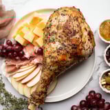A close-up of a Thanksgiving Turkey Legs Charcuterie board, brimming with savory meats and festive sides.