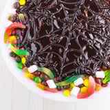 Delicious and spooky homemade spiderweb candy platter, perfect for a Halloween dessert arrangement.