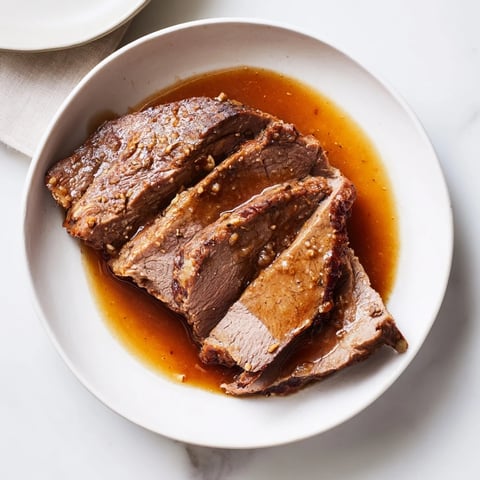 Tender Budget Holiday Chuck Roast, falling apart and ready to serve with rich, savory pan juices.