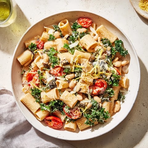A steaming bowl of Healthy Tuscan White Bean & Kale Pasta, bursting with vibrant flavors.