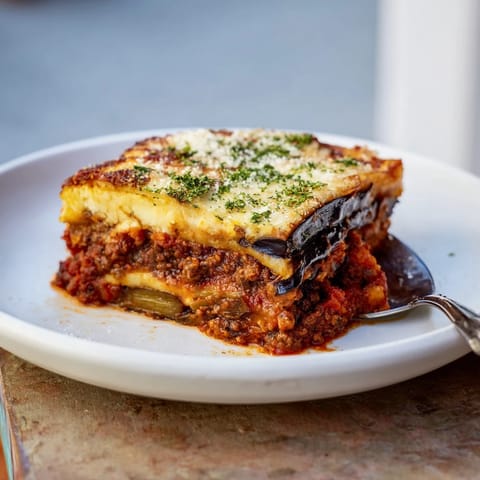 Golden Moussaka features spiced beef, tender eggplant, and creamy cheese topping.  