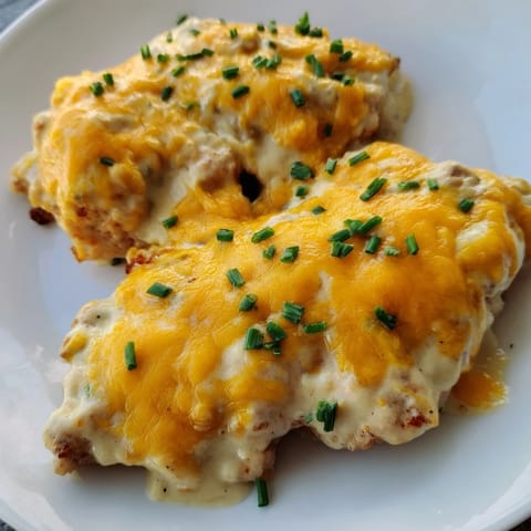 Juicy Cheddar Ranch Chicken Bake topped with melted cheese and fresh herbs.  
