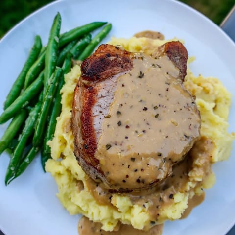 Savory Pork Chops & Cheddar Mash Bowl featuring golden seared pork chops and crisp green beans.