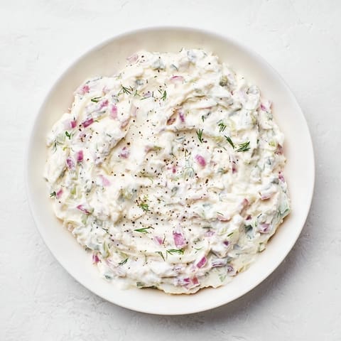 Scooping the vibrant sweet and sour pickle relish dip with tortilla chips for a tasty appetizer.