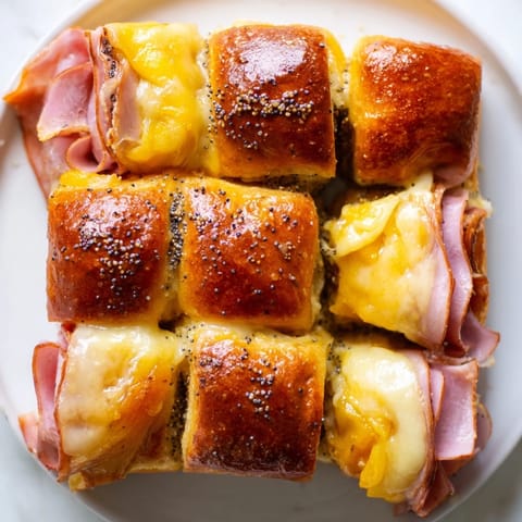 Warm Baked Ham and Cheese Party Sliders with melted Swiss and a buttery, savory glaze, ready to eat.