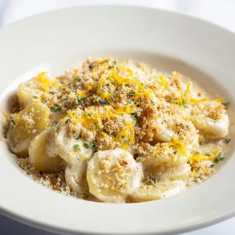 A creamy, decadent bite of cheesy scalloped potatoes, perfectly layered with cheese for richness.