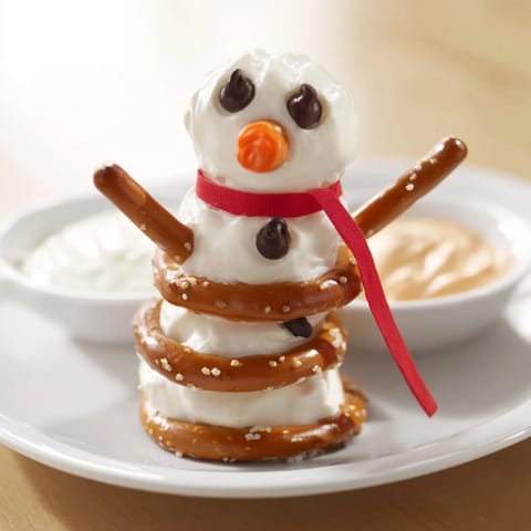 Savory snowman pretzel and dip platter features adorable pretzel figures and flavorful homemade dips.