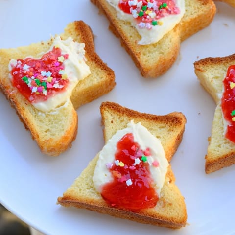 Golden-brown Elf Shoe Shaped Toast Bites with vibrant toppings arranged on a serving board.
