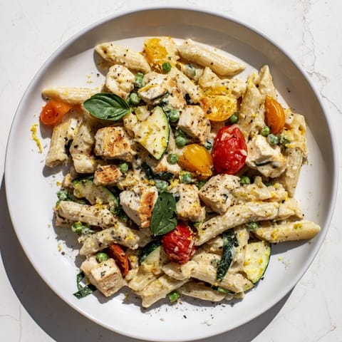 This Last Bite Chicken Pasta showcases creamy sauce, perfectly cooked pasta, and fresh basil garnish.