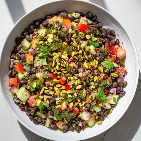 A close-up of a refreshing Dense Bean Salad with Dubai Chocolate Notes, showcasing colorful ingredients and dressing.