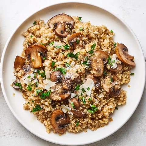 Close-up of golden Mushroom Quinoa Risotto; the quinoa is perfectly cooked in a flavorful broth.