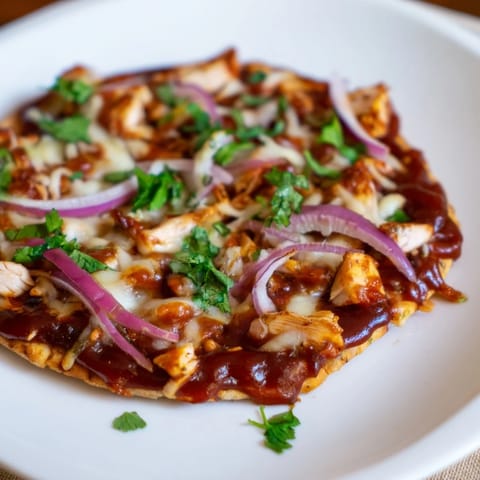 Savory BBQ chicken flatbread, featuring juicy chicken and melted cheese atop a crispy flatbread crust.