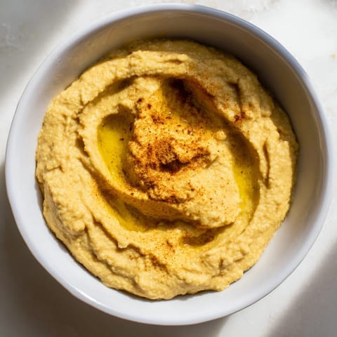 A photo showcasing a bowl of fresh, aromatic chickpea curry paste ready to be enjoyed with pita.