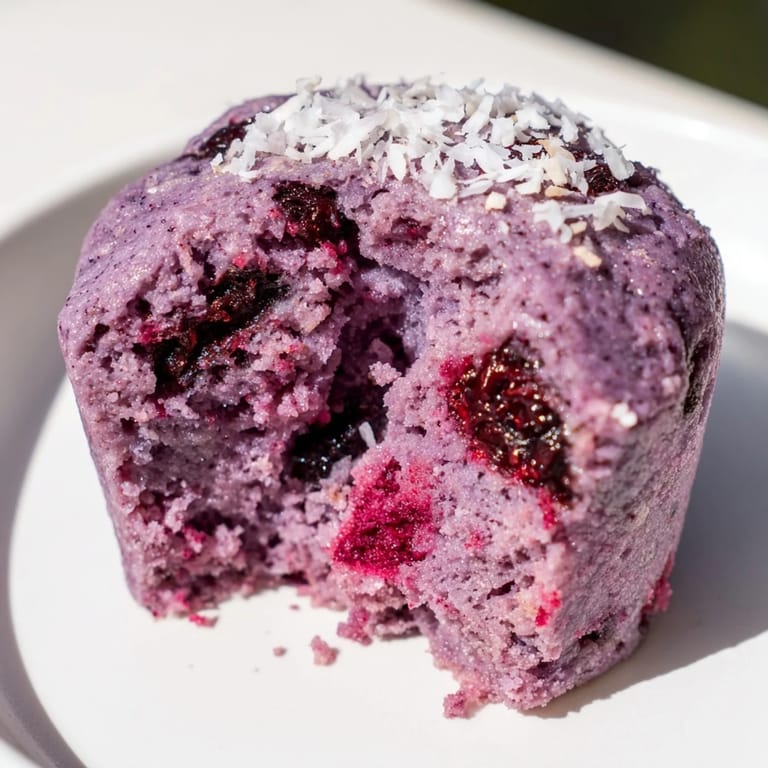 Delicious ube cranberry mochi muffins, bursting with flavor and colorful, perfect for sharing.
