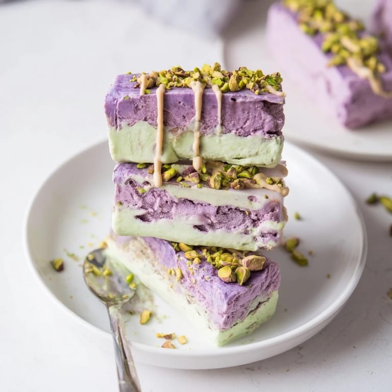 Colorful ube and nutty pistachio ice cream bars drizzled with condensed milk.  