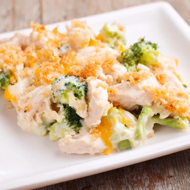 A close-up of a creamy Chicken & Broccoli Cheddar Bake, revealing cheesy goodness and tender chicken.
