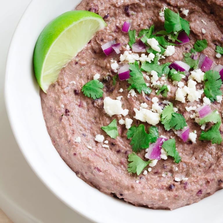 A bowl of vibrant Spicy Black Bean Dip, boasting fresh lime and jalapeño flavors, perfect for snacking.