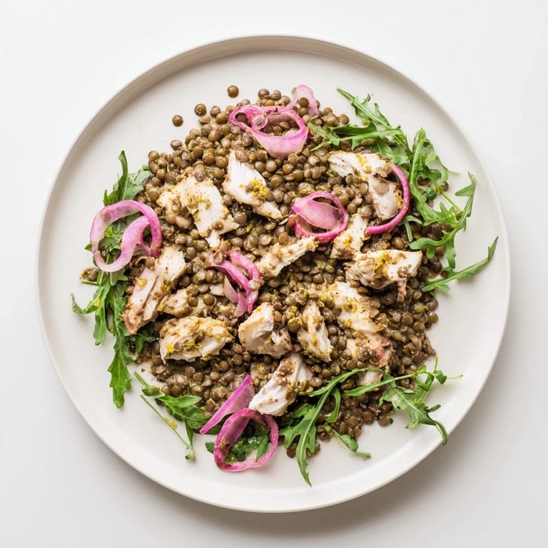 Serving suggestion for the Lentil & Chicken Spring Salad, plated with optional cucumber slices and a sprinkle of peppery arugula for a refreshing meal.