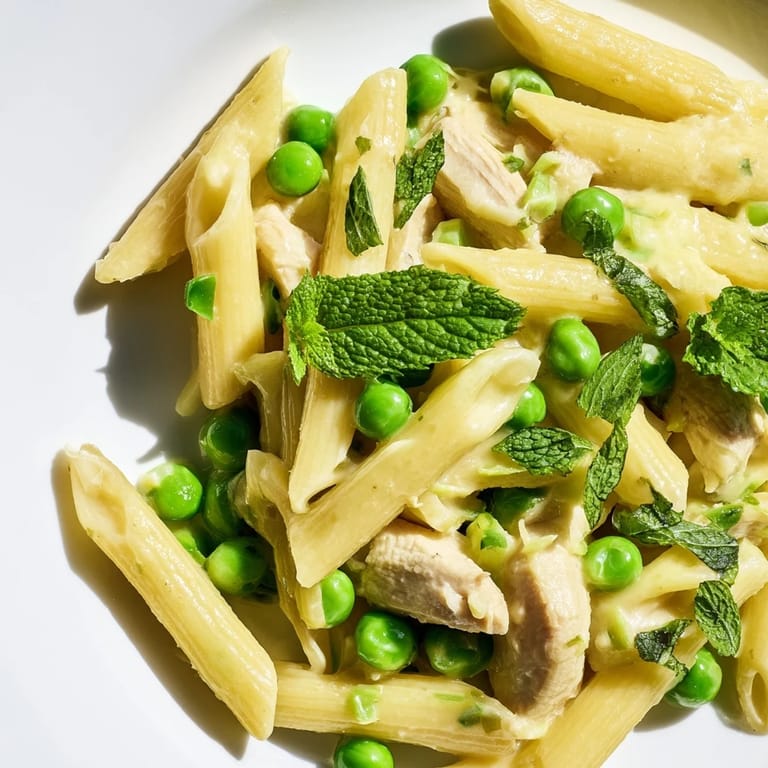 Savory strips of golden chicken breast and al dente penne are coated in a bright, buttery lemon sauce with pops of green peas.